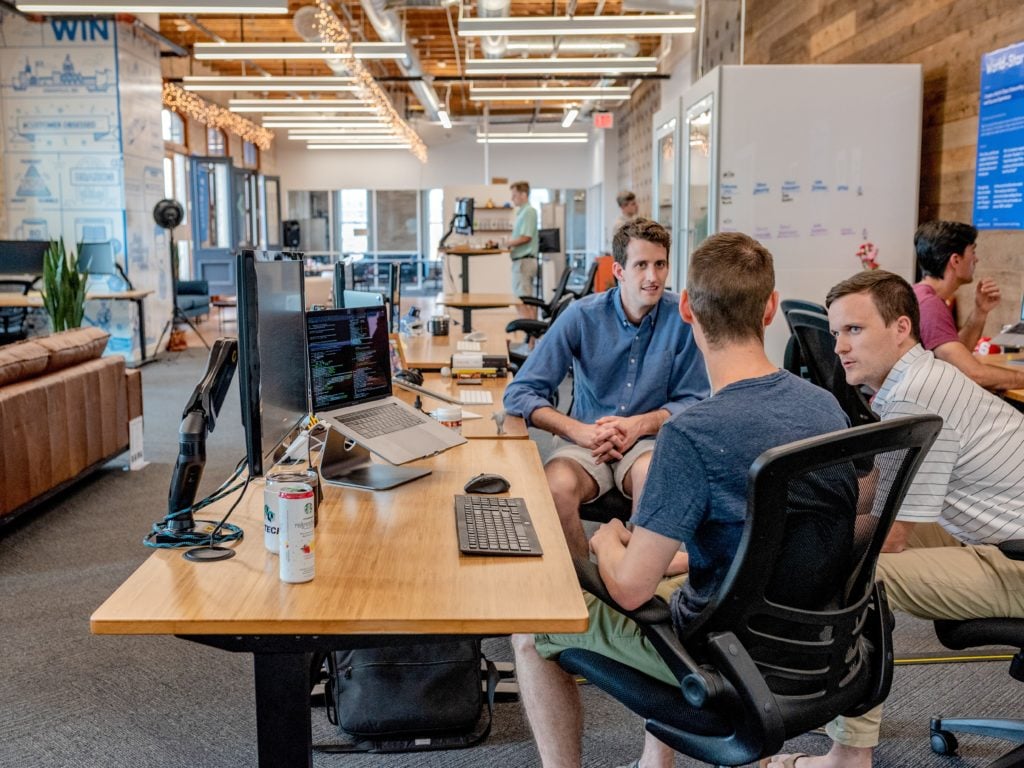 workers chatting by desk