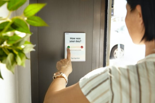 mid shot of someone from behind filling out a customer satisfaction score test