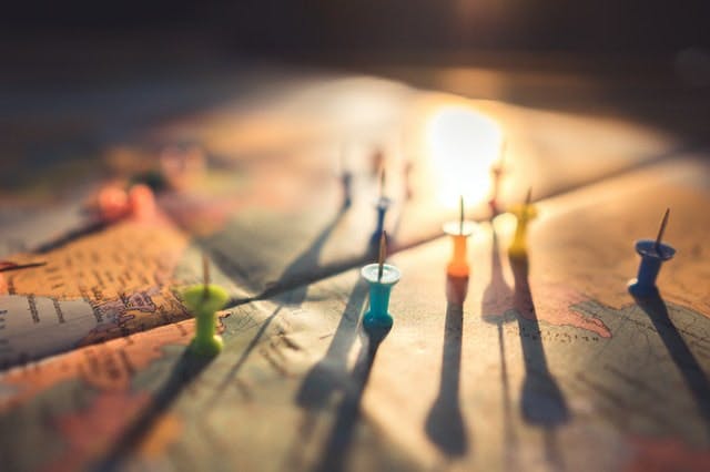 Map in warm lighting with colored push-pins on top