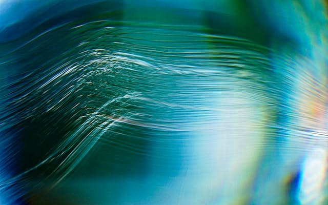 white ripples across an iridescent blue background