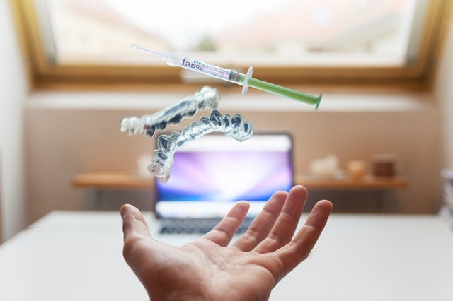 tech doctor and a laptop in the background