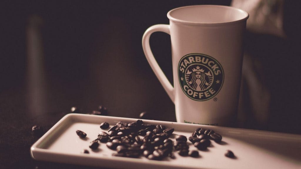 Starbucks coffee mug with beans on a plate