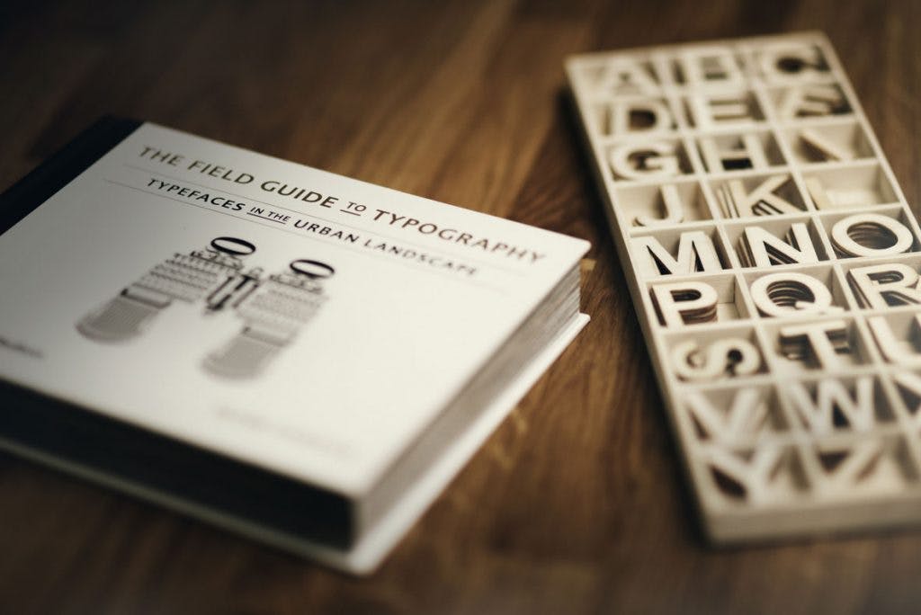 typography book next to printed letters