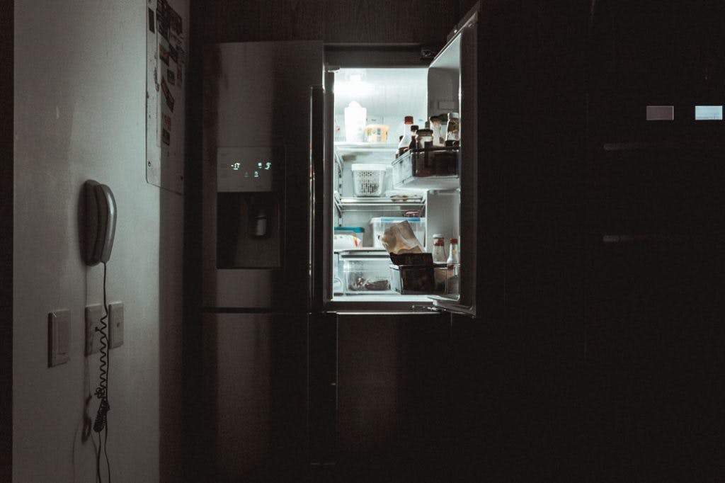 open fridge in a dark room