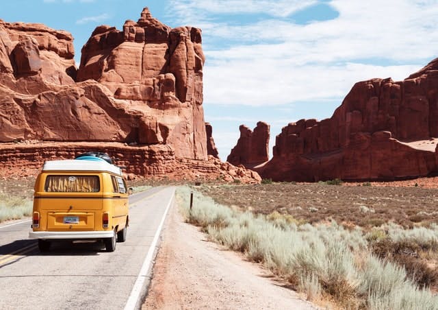 Van driving down desert road