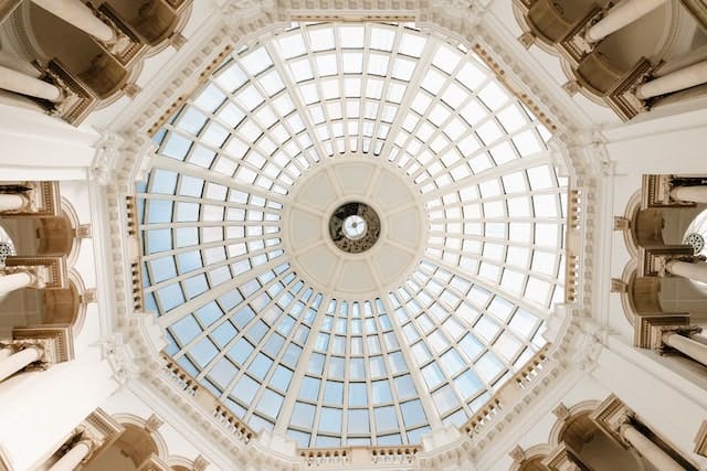 a domed glass ceiling supported by white pillars