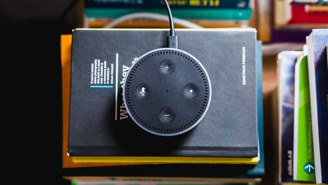 Bird's eye view of an Alexa on top of a stack of books