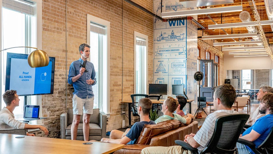 man talking to an audience in a coworking space