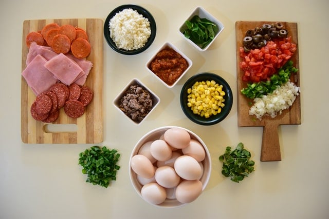 cutting boards and bowls with various ingredients prepared
