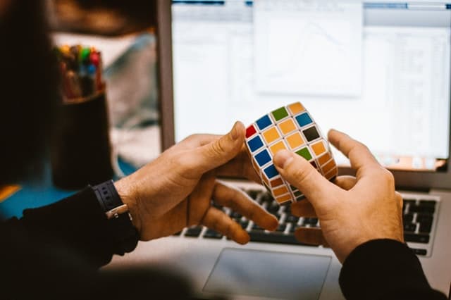 Hands playing with a rubiks cube