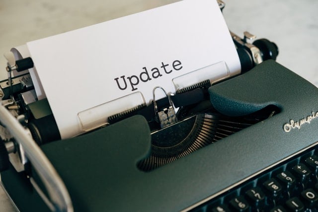 Typewriter with word update written on sheet of paper