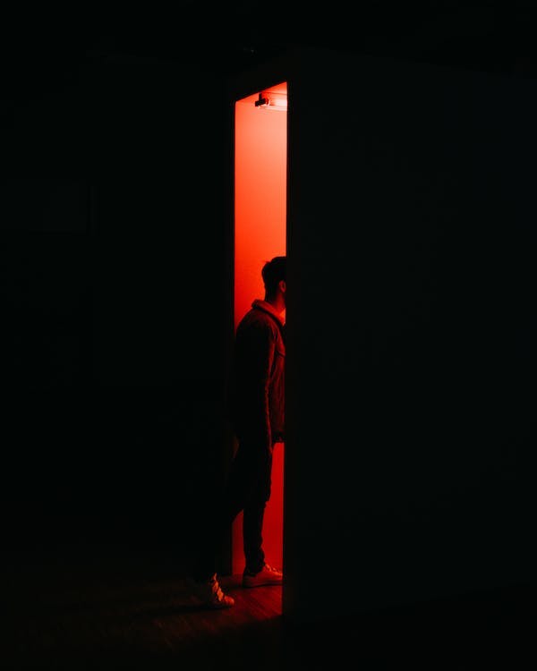 Person Standing on Opened Doorway