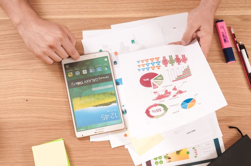 tablet and paper with data